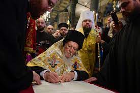 Orthodox bishop signing document