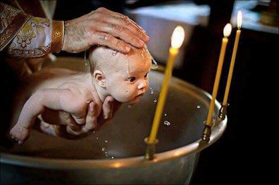 newborn being baptized