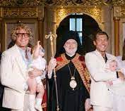 bishop with baptismal candidates, holding baby