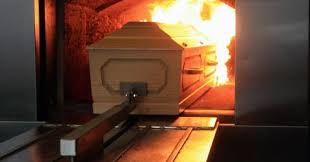 coffin going into cremation furnace