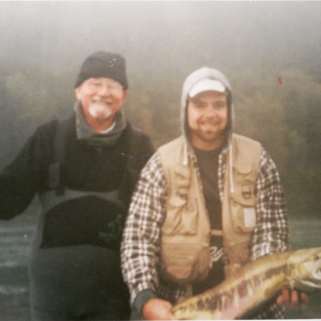 Father Tom and Deacon Kurt Jordan fishing, posing with a fish