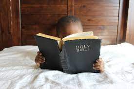 small child reading the bible