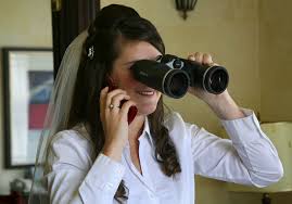 woman spying with binoculars