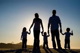 silhouette of family holding hands