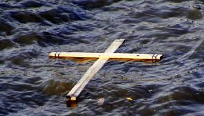 wooden cross floating on water