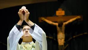 Catholic priest holding the eucharist